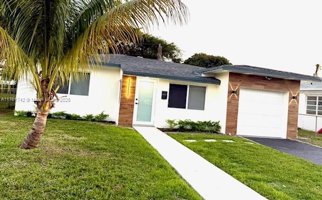 ranch-style house with stucco siding, driveway, a front lawn, and a garage