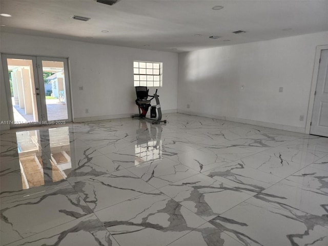 empty room featuring visible vents, recessed lighting, baseboards, and marble finish floor