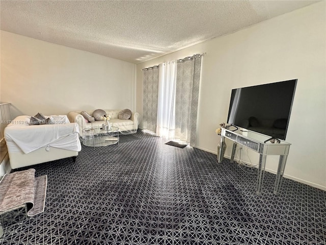 carpeted living room featuring baseboards and a textured ceiling