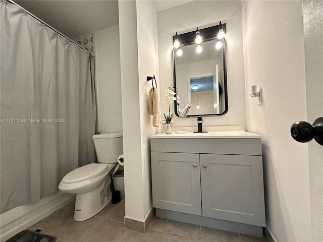 bathroom featuring tile patterned floors, toilet, curtained shower, baseboards, and vanity