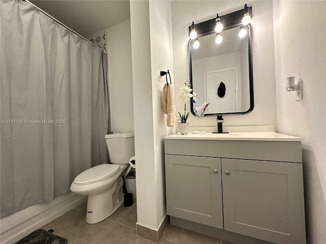 bathroom featuring tile patterned flooring, toilet, vanity, and a shower with curtain