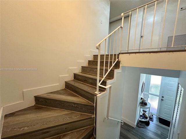 stairs featuring visible vents and wood finished floors