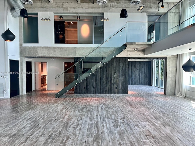 interior space featuring a high ceiling and wood finished floors