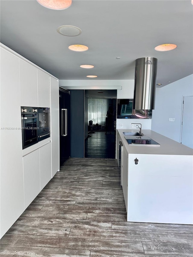 kitchen featuring white cabinetry, light countertops, modern cabinets, and dark wood-style flooring