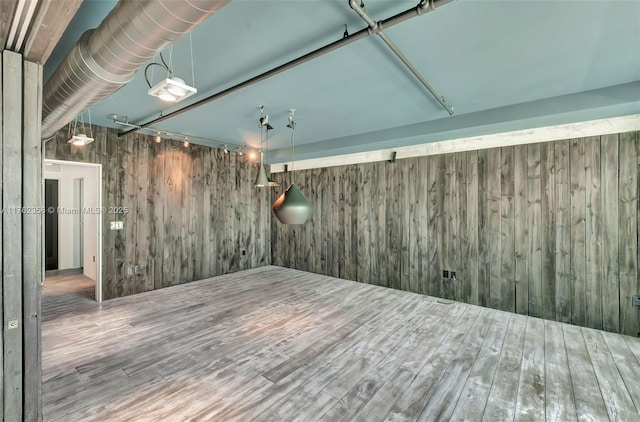 interior space featuring wood finished floors and wooden walls