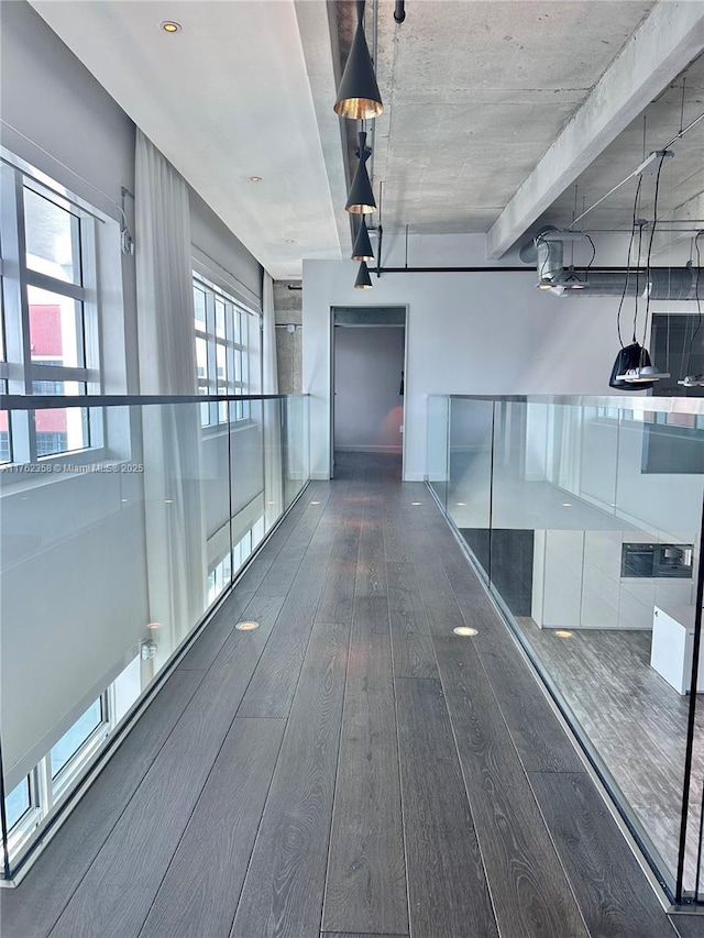 corridor with hardwood / wood-style flooring and plenty of natural light