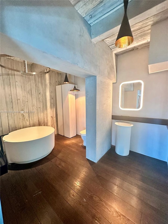 bathroom with a freestanding tub, toilet, walk in shower, and hardwood / wood-style flooring