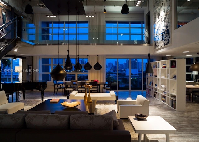 living room featuring a high ceiling and wood finished floors