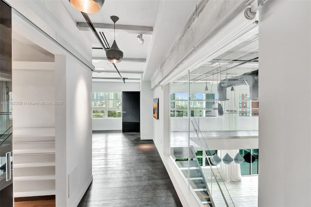 hallway featuring baseboards and hardwood / wood-style flooring