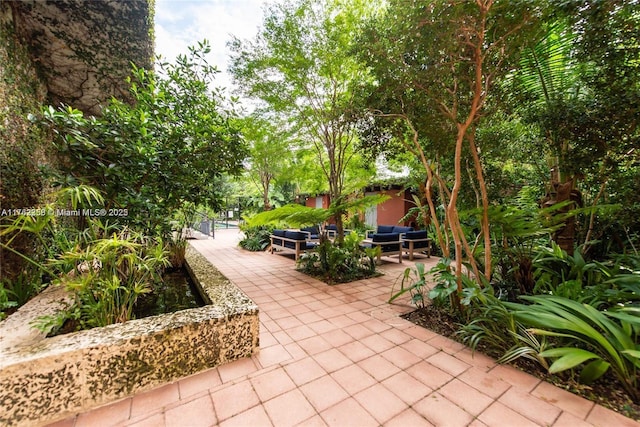 view of property's community with a patio area and an outdoor hangout area