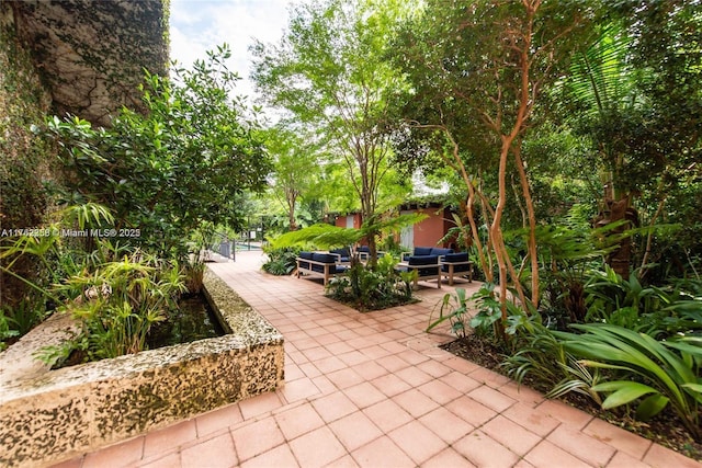 surrounding community with an outdoor living space and a patio area