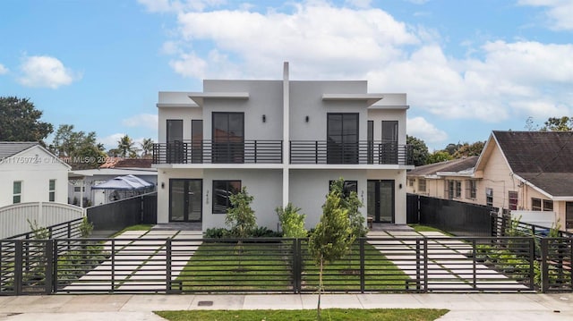 3430-3432 SW 2nd St, Miami, FL 33135 - modern home featuring a gate, a fenced front yard, and stucco siding