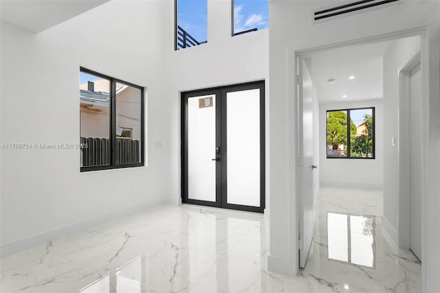 interior space with visible vents, baseboards, recessed lighting, french doors, and marble finish floor