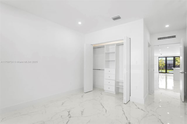 unfurnished bedroom with visible vents, baseboards, recessed lighting, a closet, and marble finish floor