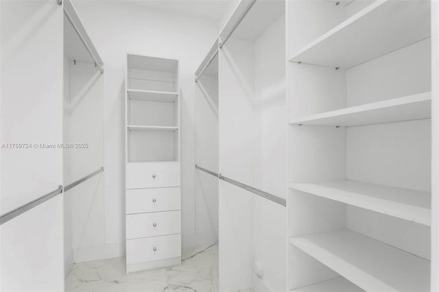 walk in closet with marble finish floor