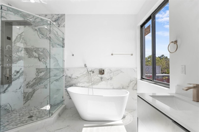 full bath featuring a marble finish shower, marble finish floor, vanity, and a freestanding tub