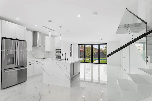 kitchen featuring white cabinets, wall chimney exhaust hood, recessed lighting, and appliances with stainless steel finishes