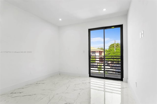 unfurnished room with recessed lighting, marble finish floor, and baseboards