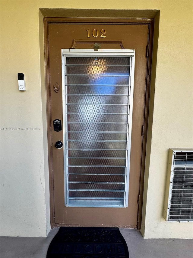 property entrance with stucco siding