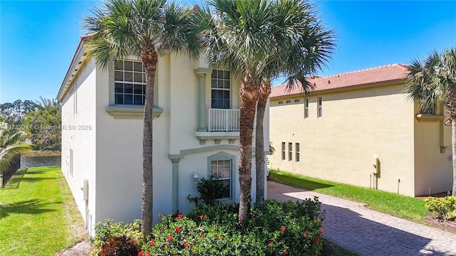 view of home's exterior featuring stucco siding and a lawn