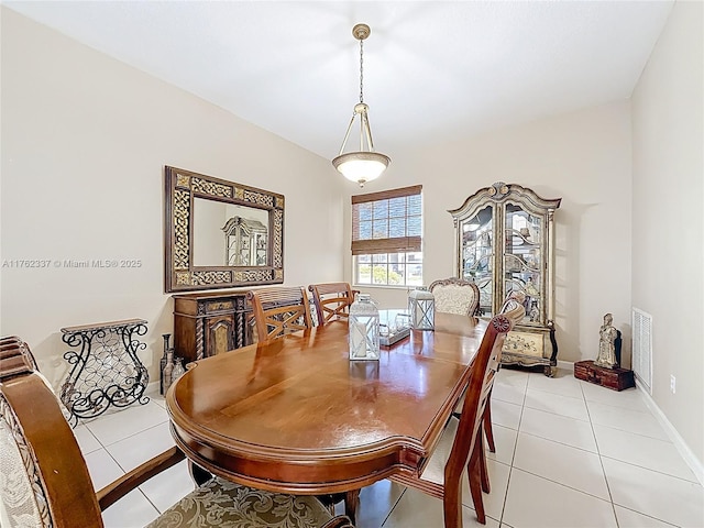 tiled dining space featuring visible vents and baseboards