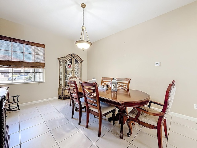 dining room with light tile patterned floors and baseboards