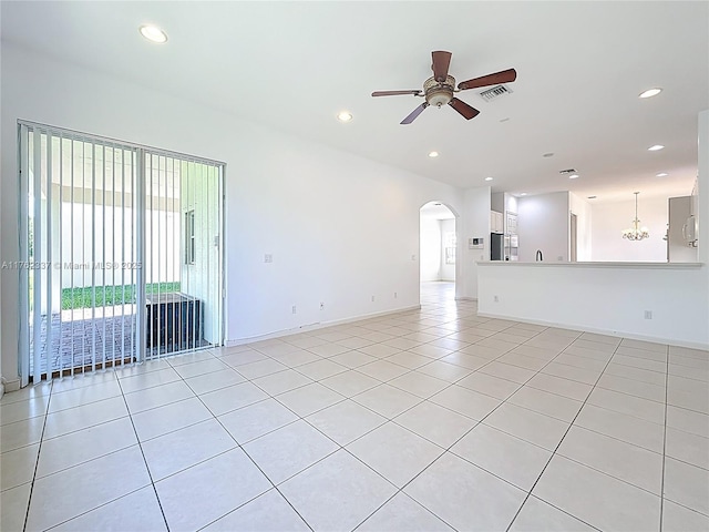 2217 SW Newport Isles Blvd, Port St Lucie, FL 34953 - unfurnished living room with a ceiling fan, light tile patterned flooring, arched walkways, and recessed lighting