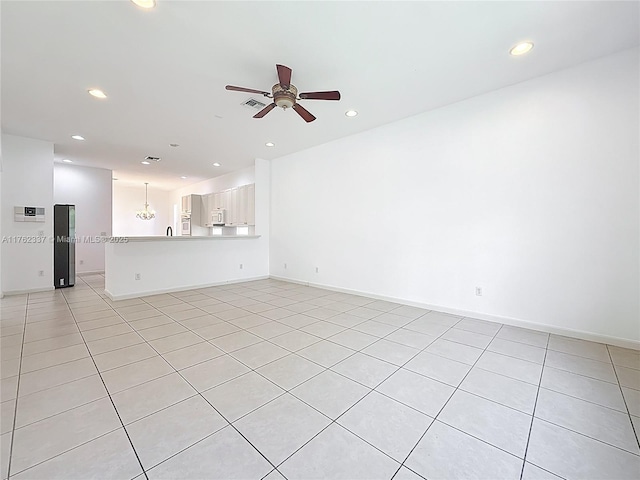 2217 SW Newport Isles Blvd, Port St Lucie, FL 34953 - unfurnished living room with ceiling fan, recessed lighting, and light tile patterned floors