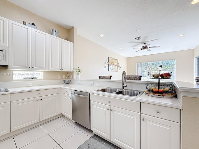 kitchen featuring a sink, visible vents, stainless steel dishwasher, and light countertops