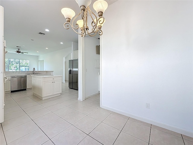 2217 SW Newport Isles Blvd, Port St Lucie, FL 34953 - kitchen featuring refrigerator with ice dispenser, stainless steel dishwasher, light countertops, white cabinets, and a chandelier
