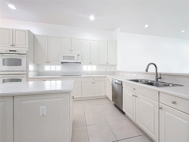 2217 SW Newport Isles Blvd, Port St Lucie, FL 34953 - kitchen with white appliances, light countertops, light tile patterned floors, white cabinetry, and recessed lighting