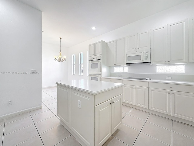 2217 SW Newport Isles Blvd, Port St Lucie, FL 34953 - kitchen with white appliances, light countertops, a chandelier, light tile patterned floors, and a center island