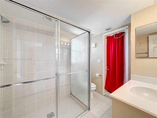 full bathroom featuring tile patterned flooring, visible vents, a shower stall, vanity, and a textured ceiling