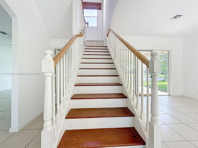 2217 SW Newport Isles Blvd, Port St Lucie, FL 34953 - stairway featuring tile patterned flooring and baseboards