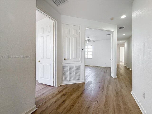 2217 SW Newport Isles Blvd, Port St Lucie, FL 34953 - corridor featuring wood finished floors and a textured wall