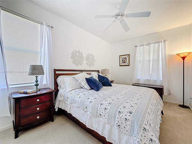 bedroom with multiple windows, light carpet, ceiling fan, and vaulted ceiling