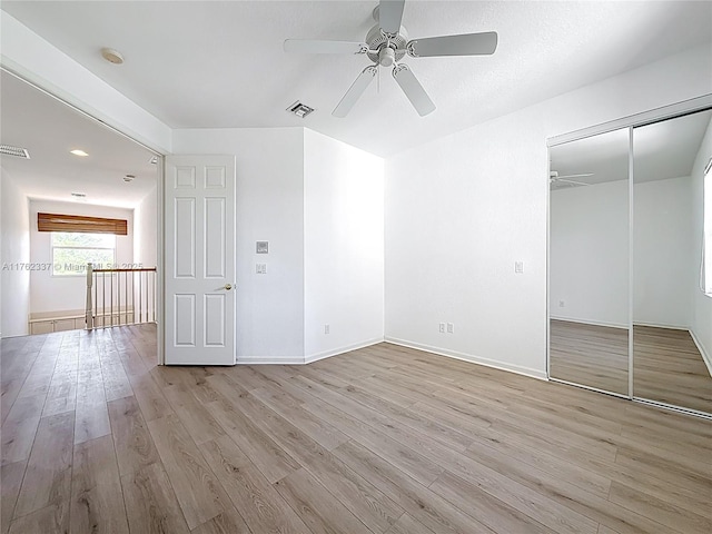 2217 SW Newport Isles Blvd, Port St Lucie, FL 34953 - unfurnished bedroom with light wood-style floors, a closet, and ceiling fan