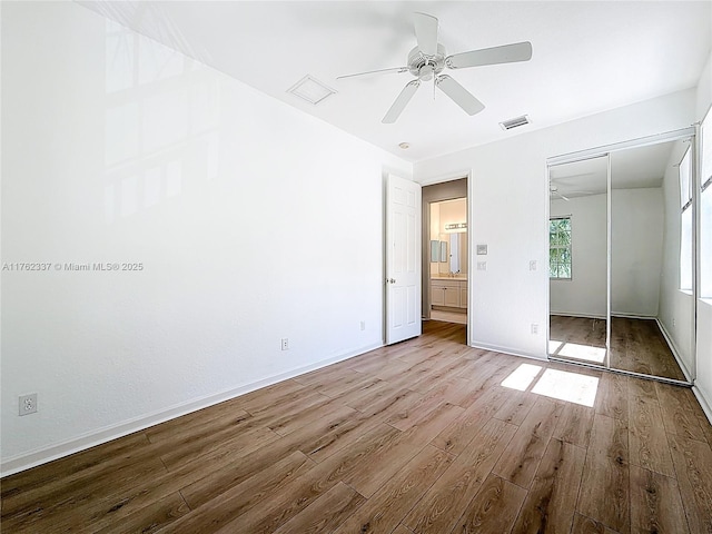 2217 SW Newport Isles Blvd, Port St Lucie, FL 34953 - unfurnished bedroom featuring wood finished floors, a closet, and ceiling fan