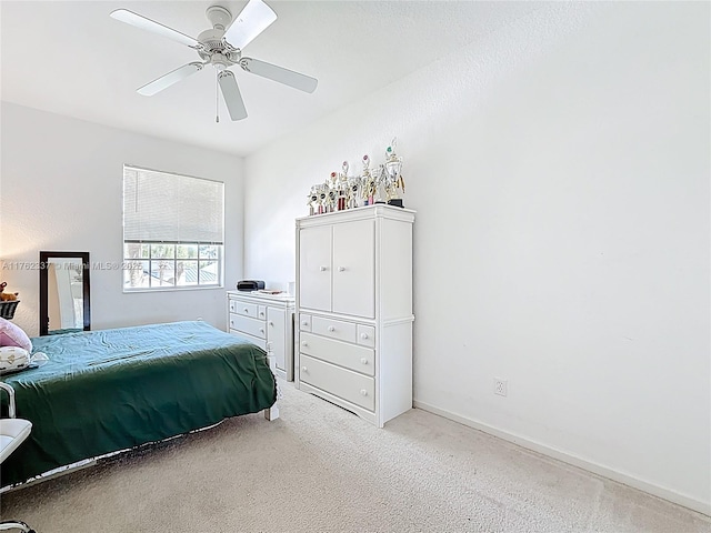 bedroom with ceiling fan, baseboards, and light carpet