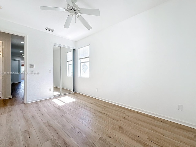 2217 SW Newport Isles Blvd, Port St Lucie, FL 34953 - unfurnished bedroom with light wood-type flooring, a closet, and ceiling fan