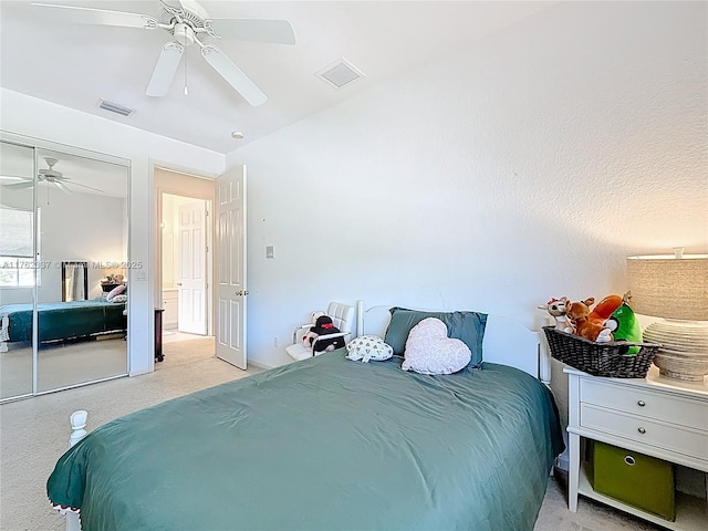 bedroom with carpet flooring, a ceiling fan, visible vents, and a closet