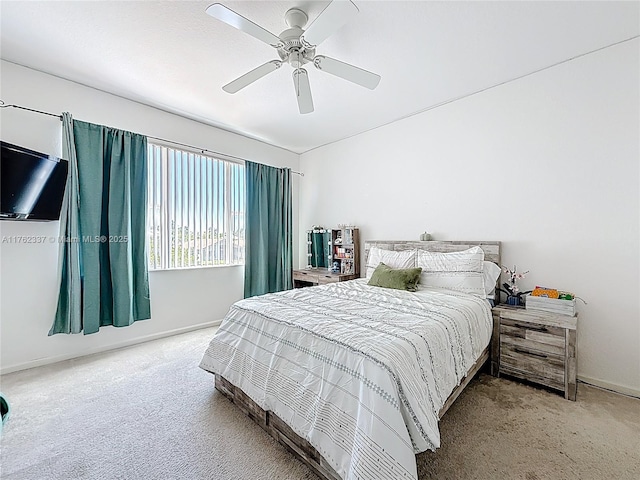 bedroom with ceiling fan, baseboards, and carpet