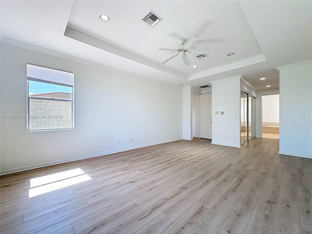 2217 SW Newport Isles Blvd, Port St Lucie, FL 34953 - spare room featuring a tray ceiling, a ceiling fan, light wood-type flooring, recessed lighting, and crown molding