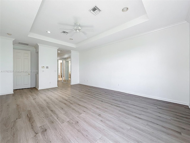 2217 SW Newport Isles Blvd, Port St Lucie, FL 34953 - spare room with a tray ceiling, ceiling fan, light wood-style floors, recessed lighting, and crown molding