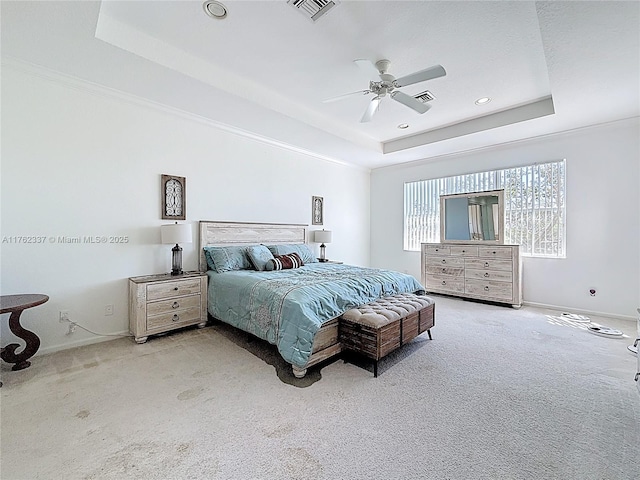 bedroom with baseboards, visible vents, a raised ceiling, and carpet floors