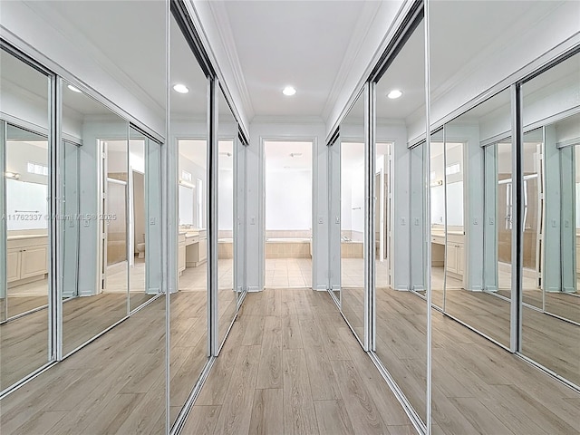 2217 SW Newport Isles Blvd, Port St Lucie, FL 34953 - hallway featuring crown molding, light wood-style floors, and recessed lighting