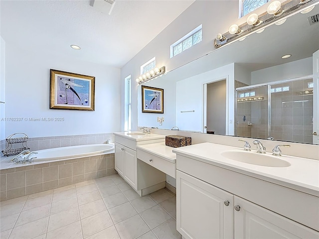 full bathroom featuring a bath, visible vents, a stall shower, and a wealth of natural light