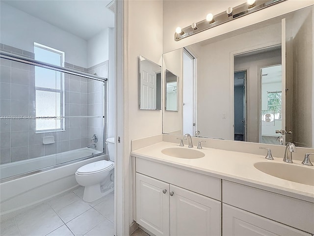 2217 SW Newport Isles Blvd, Port St Lucie, FL 34953 - bathroom with double vanity, combined bath / shower with glass door, and tile patterned flooring