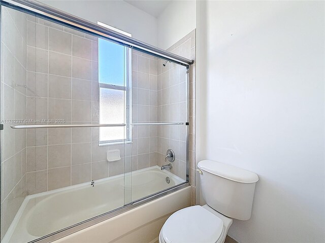2217 SW Newport Isles Blvd, Port St Lucie, FL 34953 - full bathroom with toilet and bath / shower combo with glass door