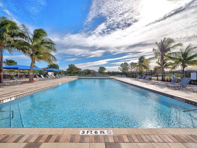 pool featuring a patio area and fence